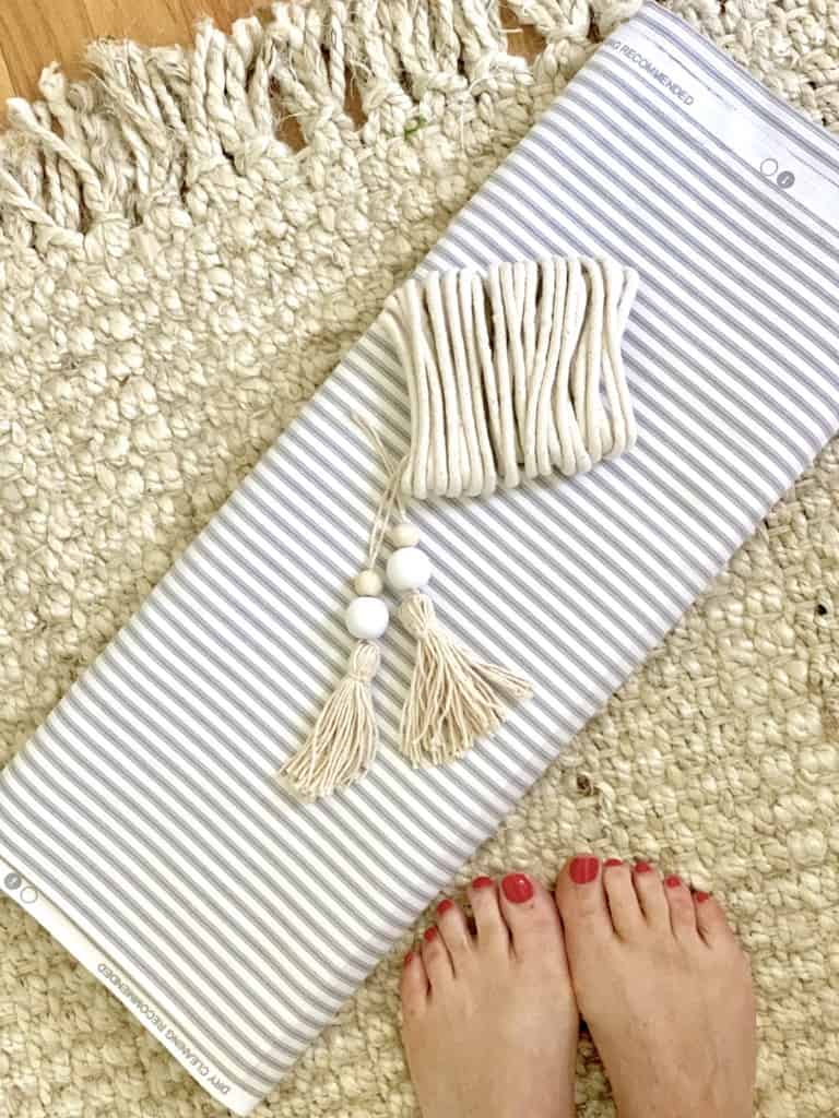 ticking stripe, fabric, tassels on a jute rug