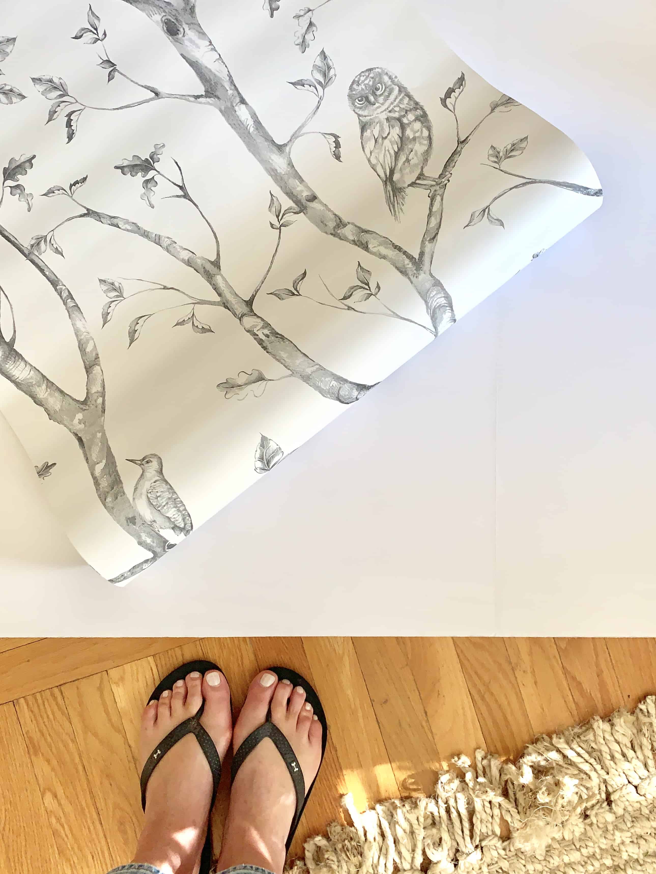 Wallpaper and board. Supplies for a DIY fireplace cover board.