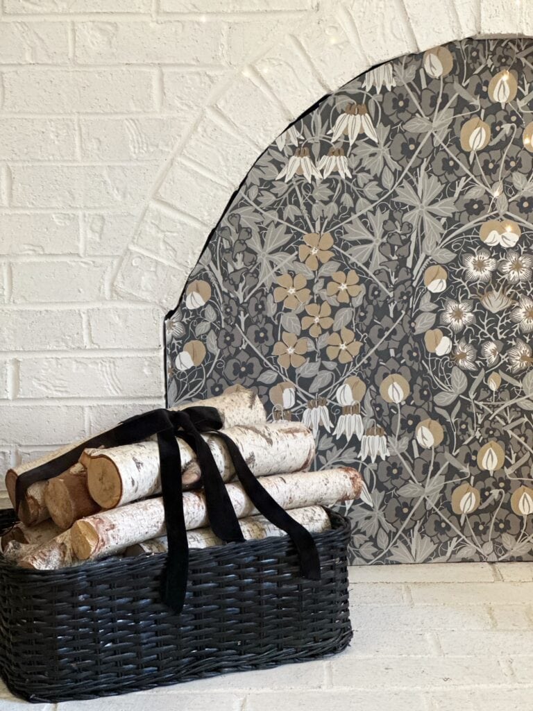 New cover board with a wallpaper that has a black background with neutral tone flowers. 