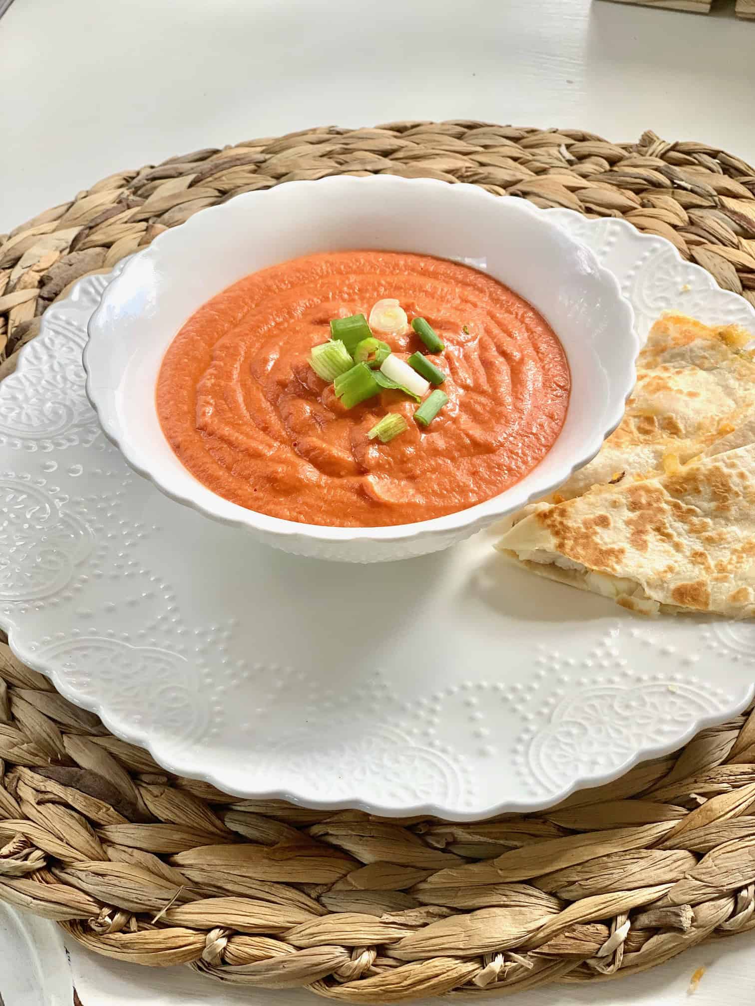 Creamy tomato soup with green onions and a quesadilla. 