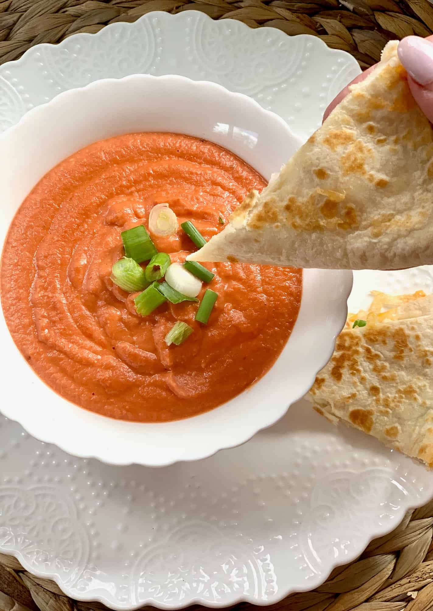 Dipping a quesadilla in the tomato soup.  