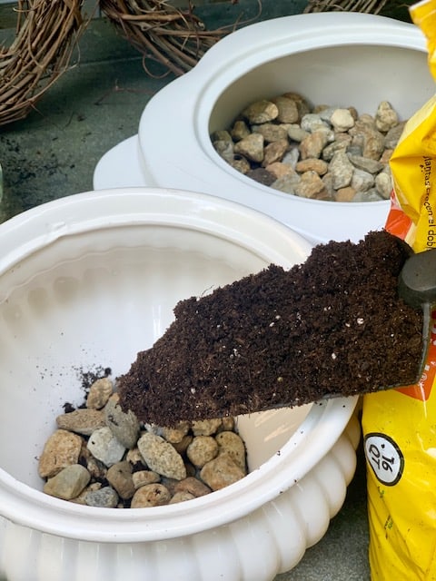 potting soil in garden shovel