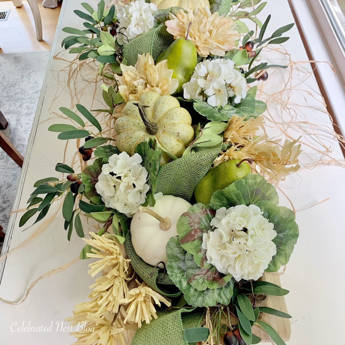Green, gold and cream dough bowl arrangement with faux fruit and flowers plus mini white pumpkins.