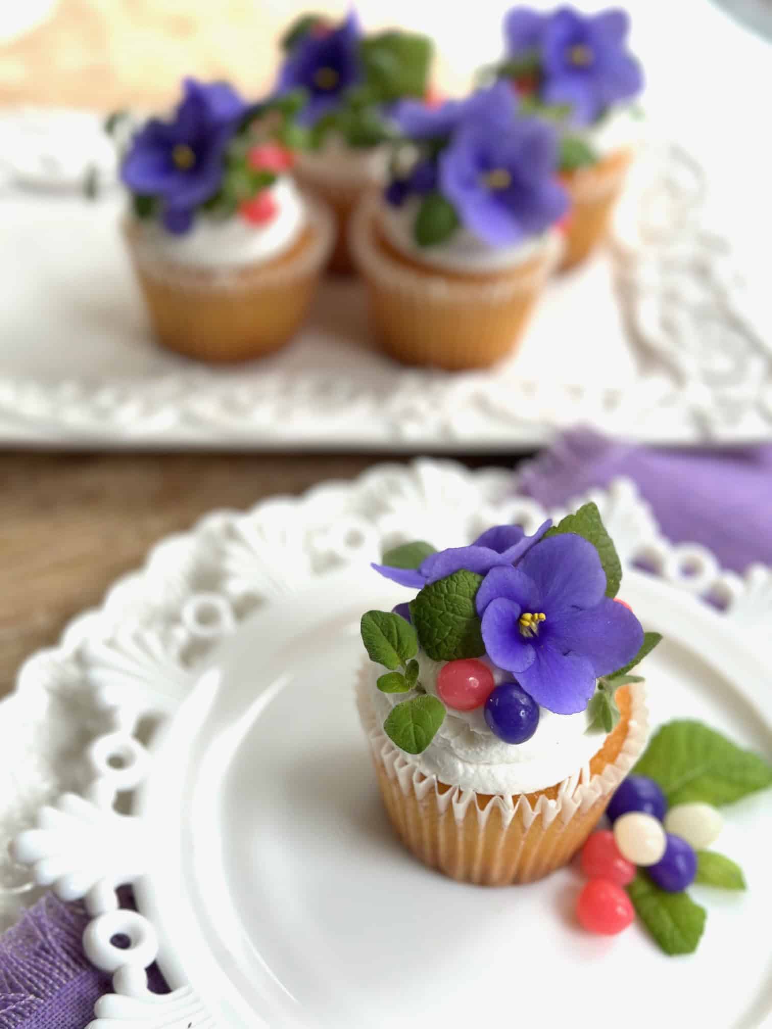 Cupcakes with violets, mint and jelly beans. 