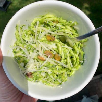 a small bowl of zucchini noodles with parsley pesto