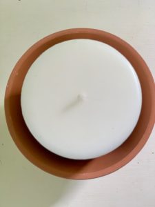 candle on top of rocks in clay pot