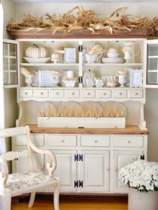 fall decorated dining hutch with neutral colors