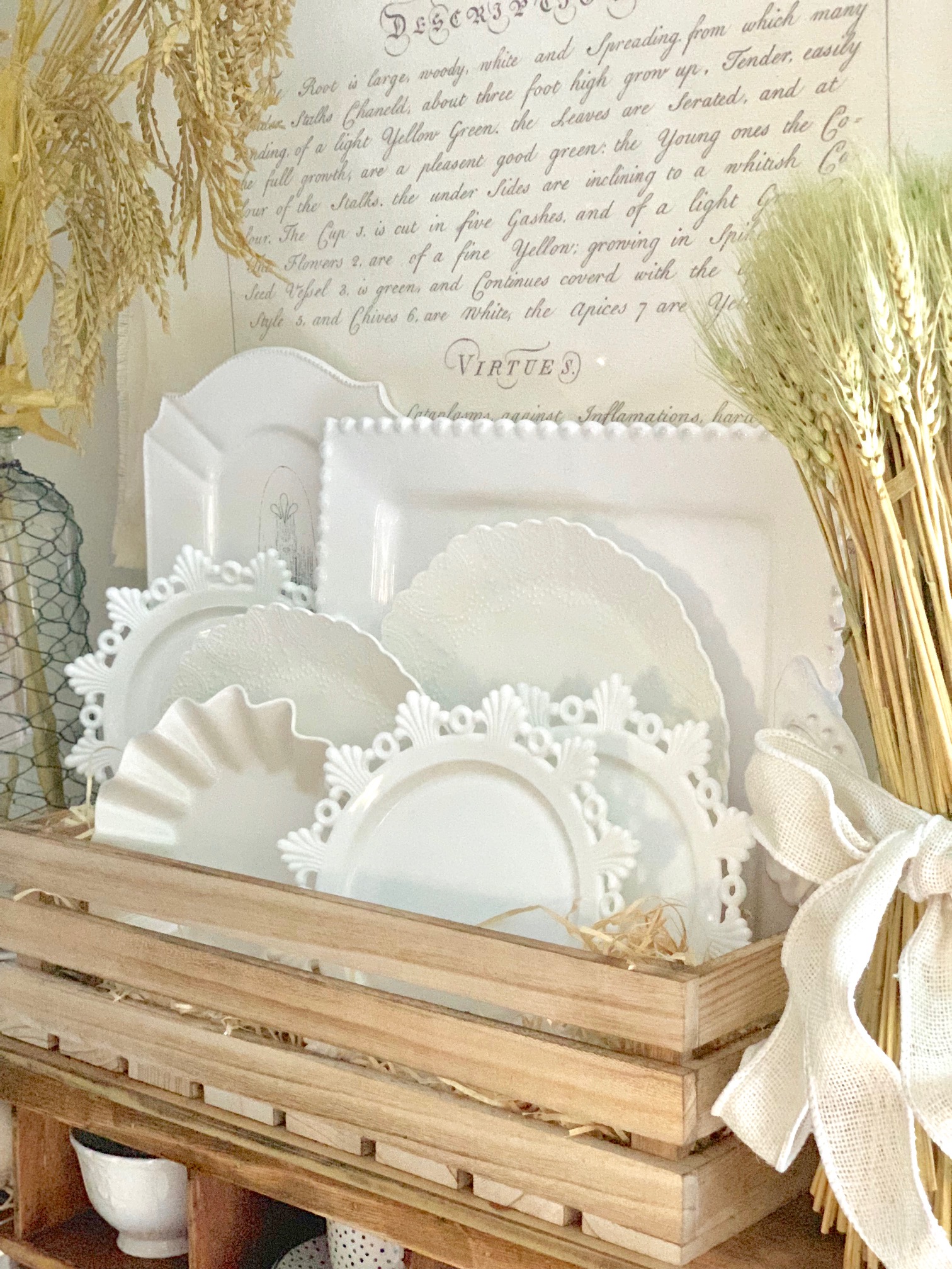 A close up of stacked dishes with a wheat bundle.