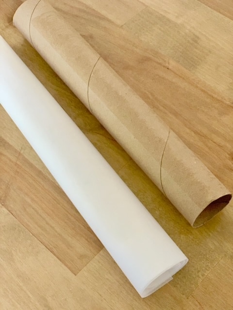 rolled dough in parchment paper and paper towel roll