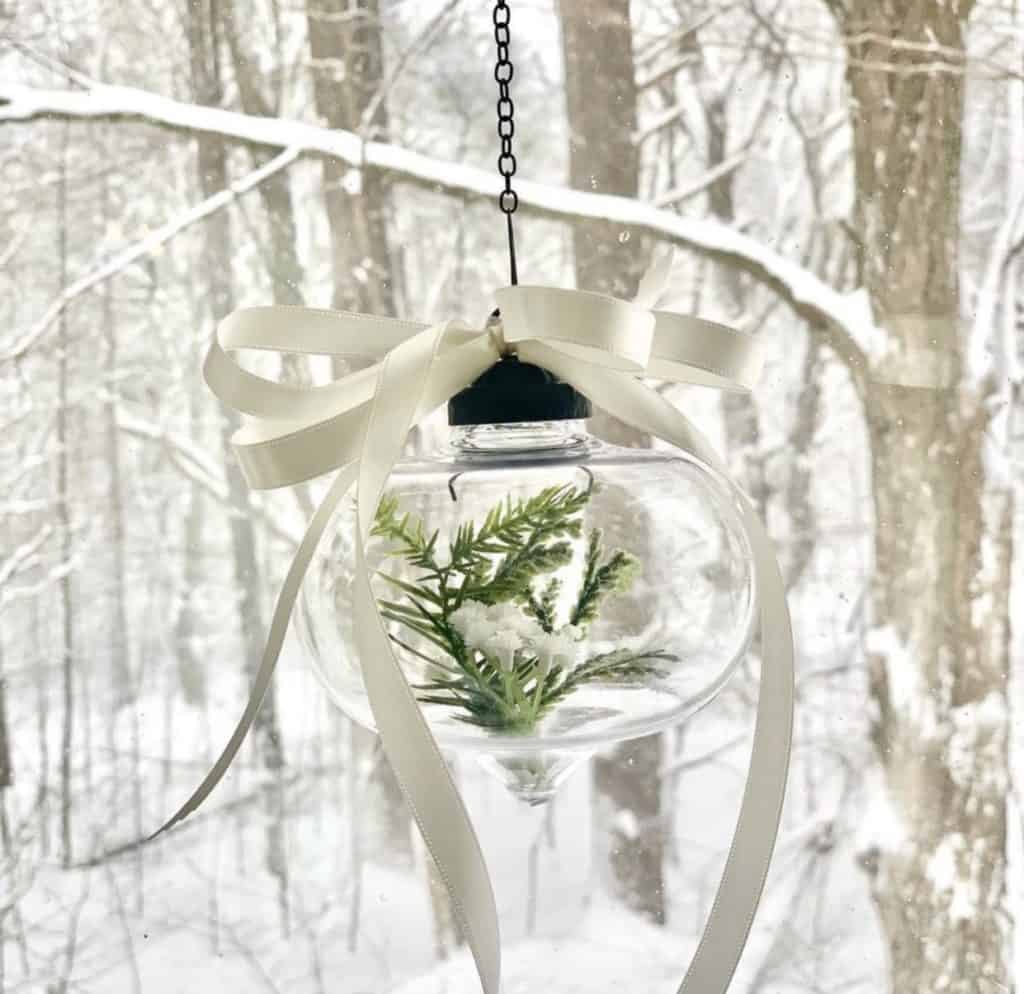 A vintage inspired glass ornaments with greens inside and a bow. These are hanging in our bay window.