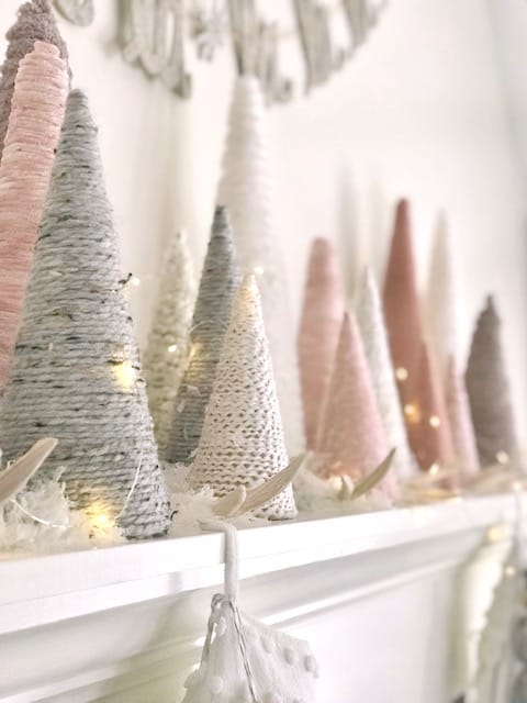 a close up of the yarn trees along the mantel