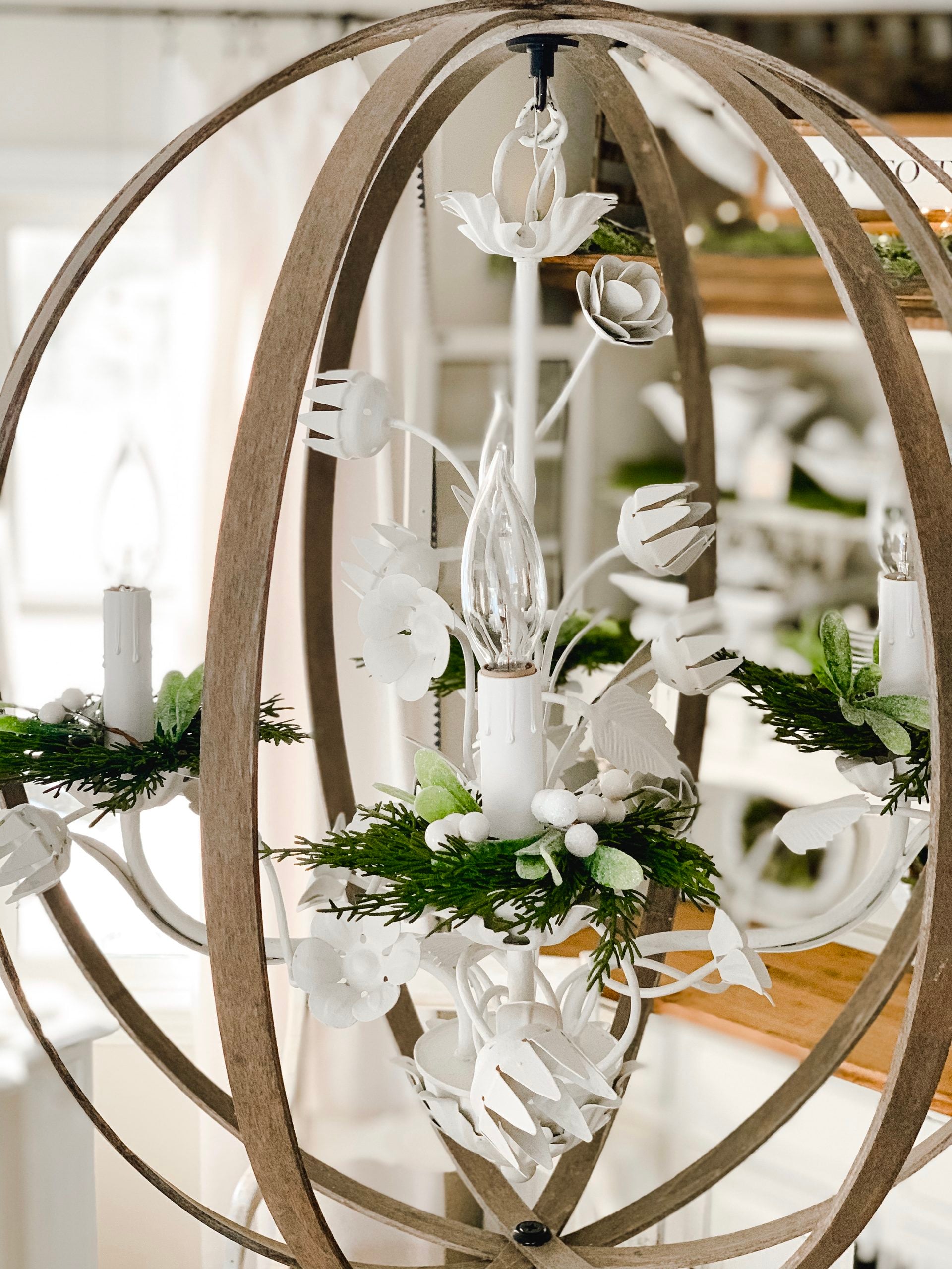 Our dining light fixture with sprigs of Christmas greens. 