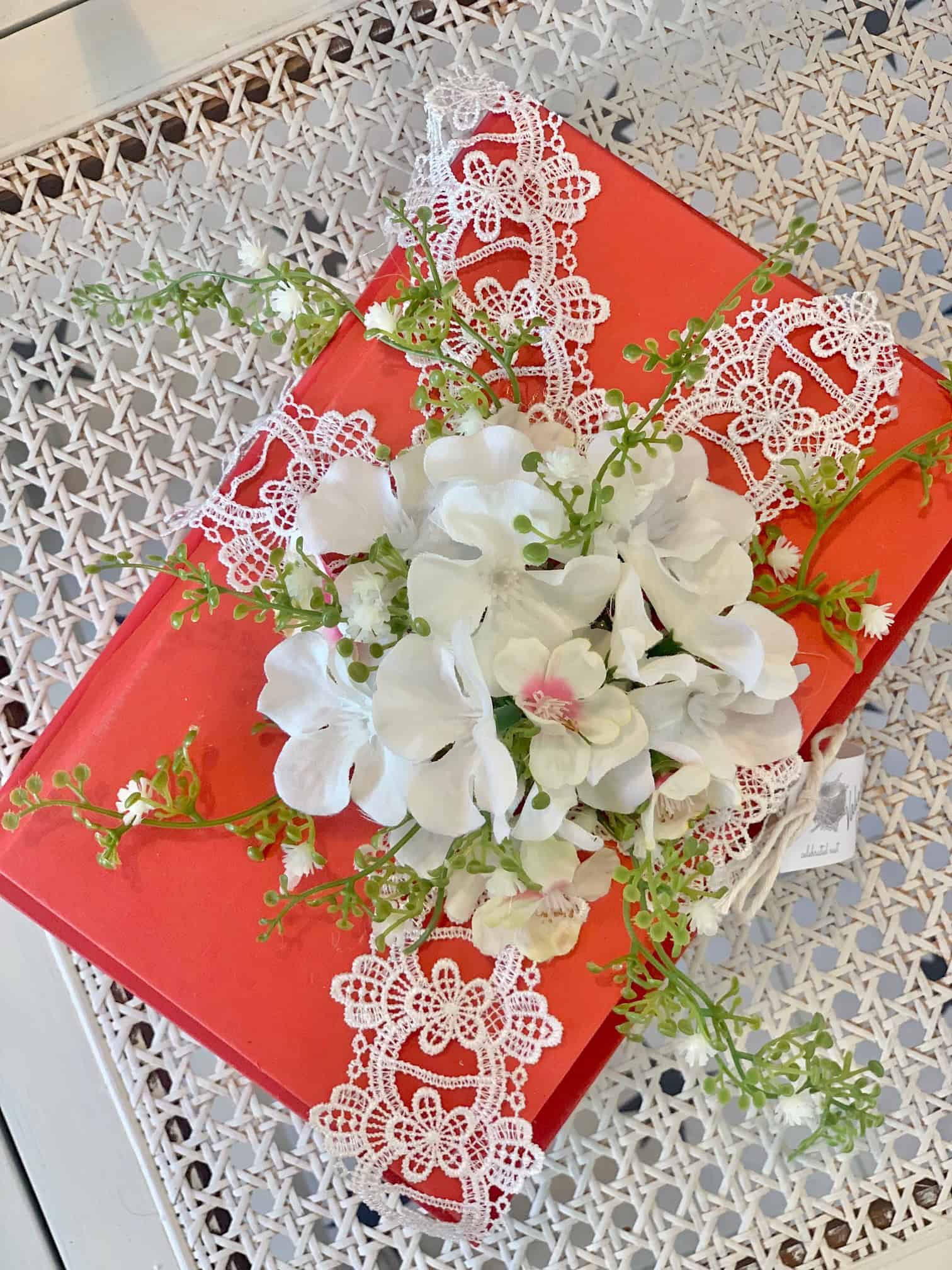 A red DIY book stack for Valentine's decor.