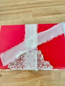 placing a cut strip of chiffon ribbon and laying it diagonally across the top of the book.