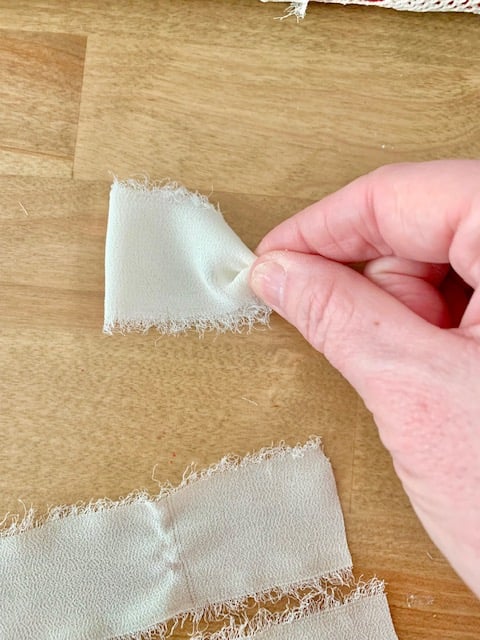 Pinching the base of the loop.