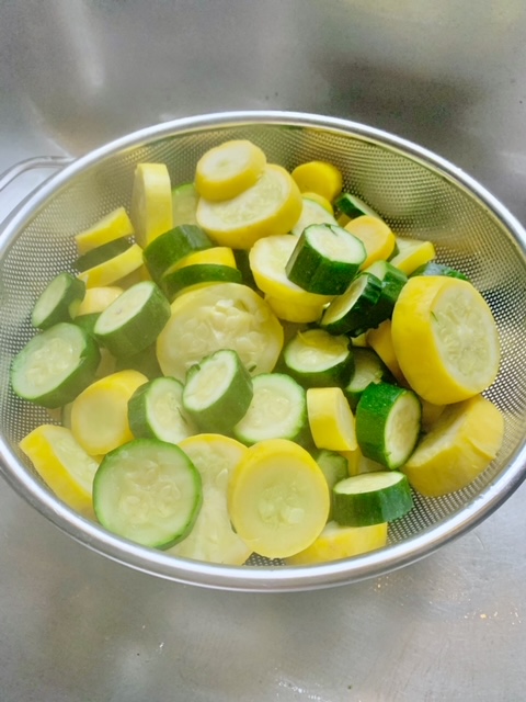 steamed zucchini and squash in colander to strain.
