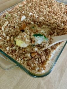 a scoop of baked zucchini and yellow squash casserole