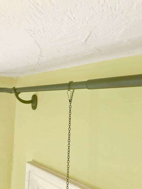 curtain rod holding the chain with the bulb pin. 