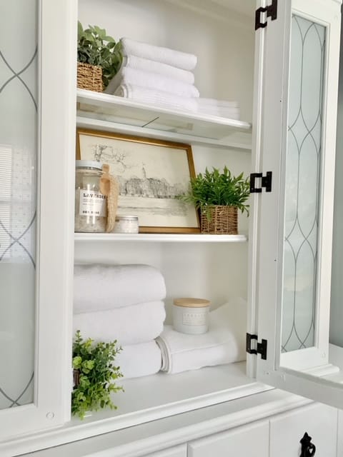 apothecary with hutch used as a linen closet in our guest bedroom. 