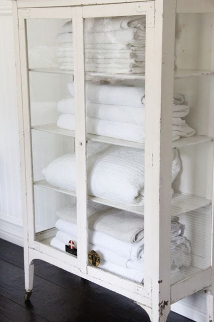 stock image of a glass door nlinen chest