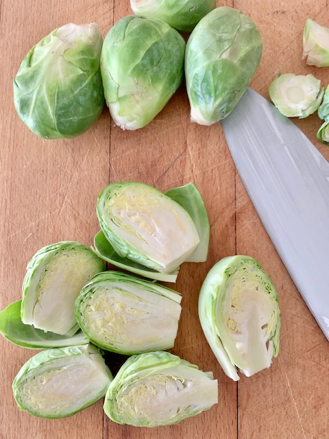 cutting brussel sprouts in half.