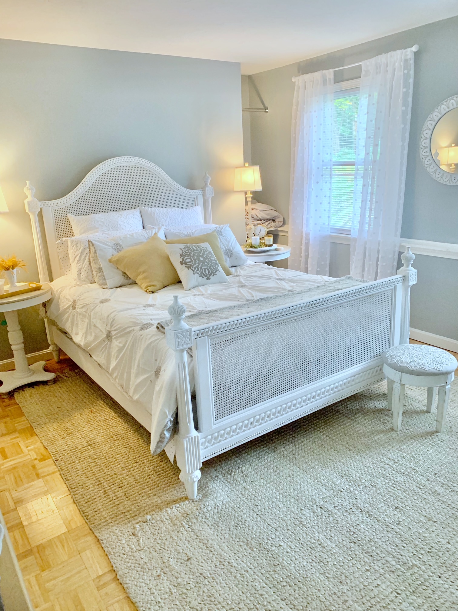 guest bedroom with stool at the foot of the bed. this bedroom is gray, white and gold so the gray stool fits perfectly.