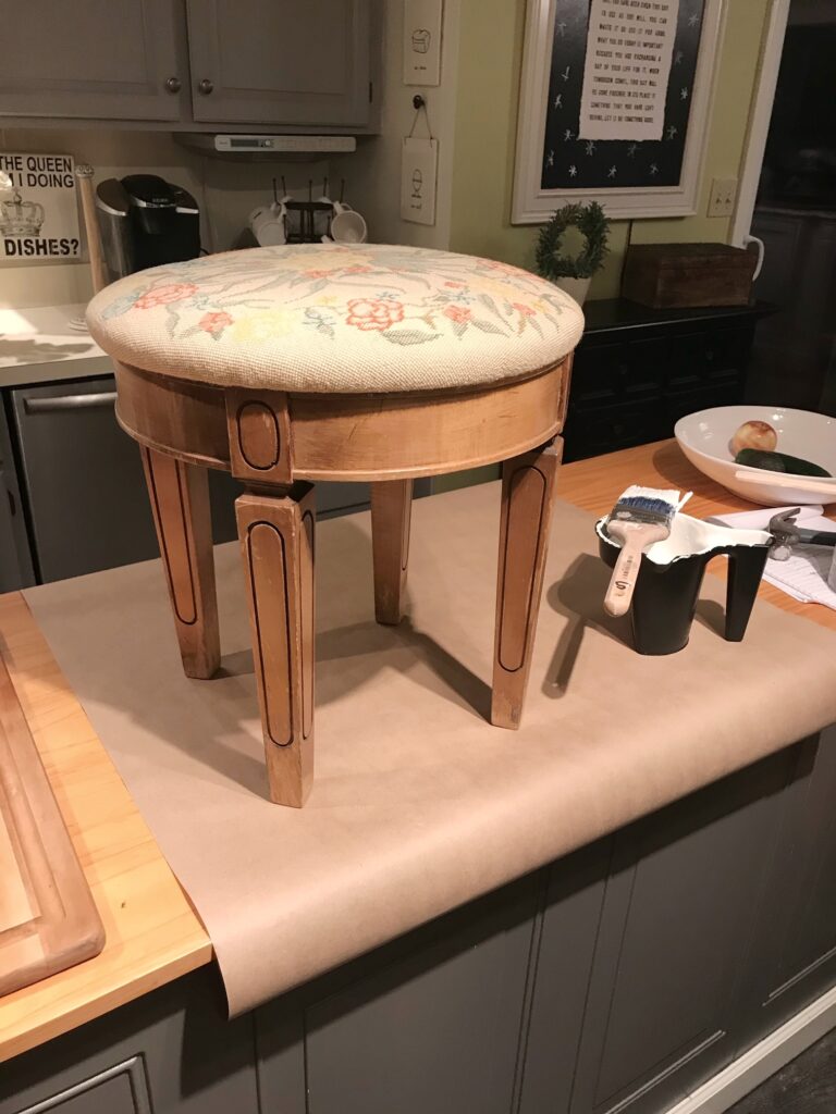 stool on kitchen island on kraft paper ready for painting