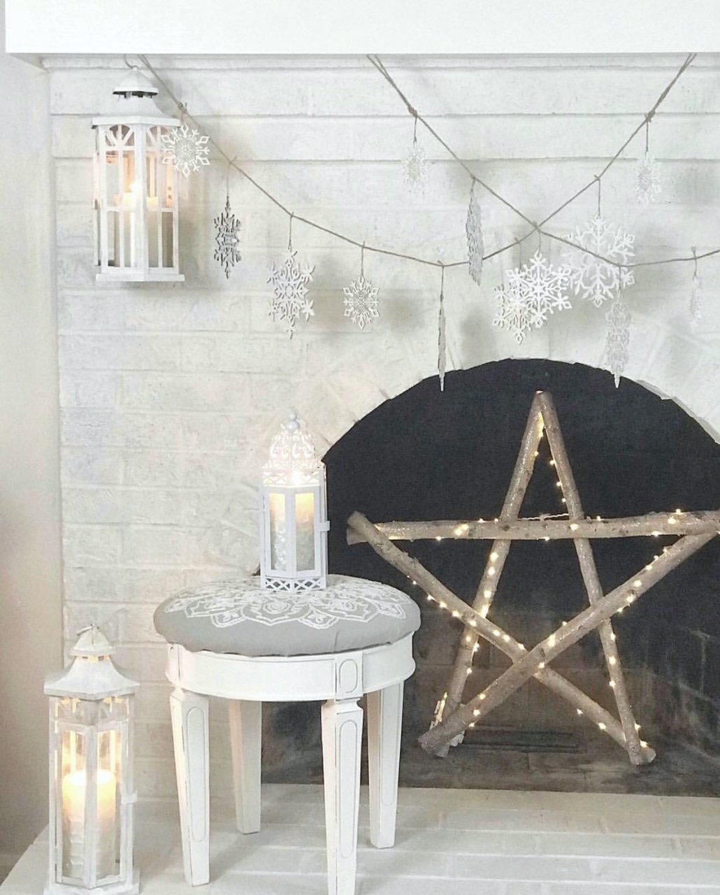 stool painted with white chalk paint with a gray cushion cover on a fireplace hearth.