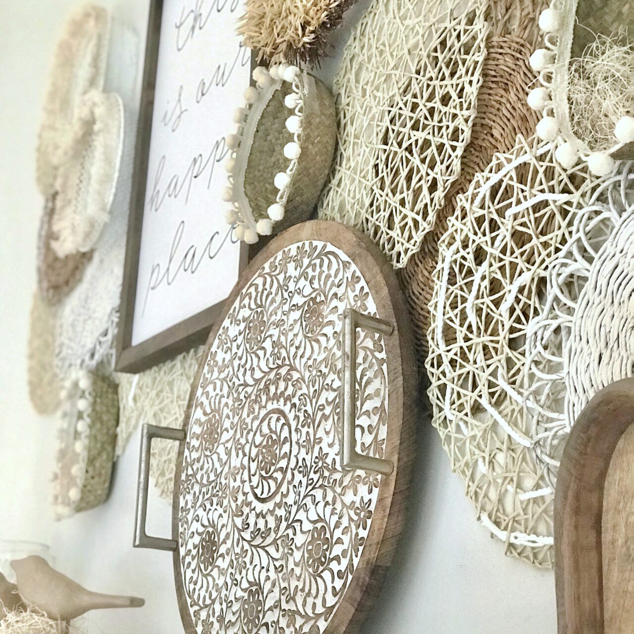 baskets, trays and other wicker/woven items hung over a white mantel.