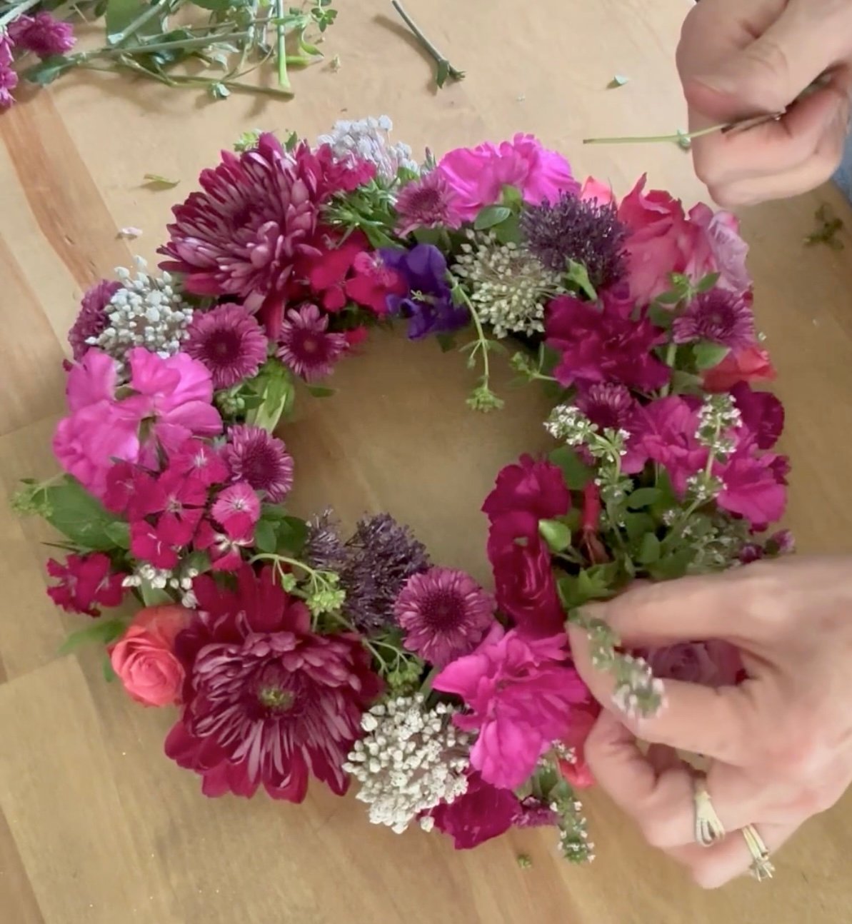 Me designing this brightly colored floral candle ring on Instagram. 