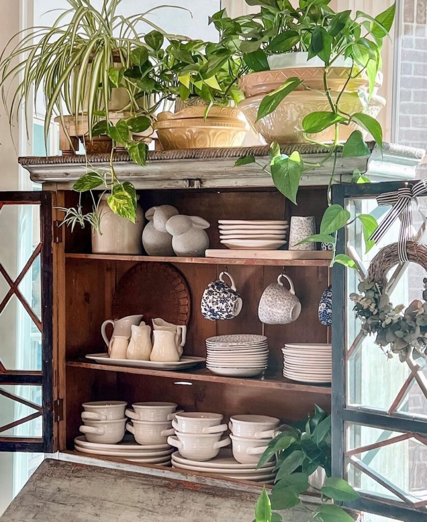 Beautiful hutch with pothos plants sitting in ceramic bowl. 