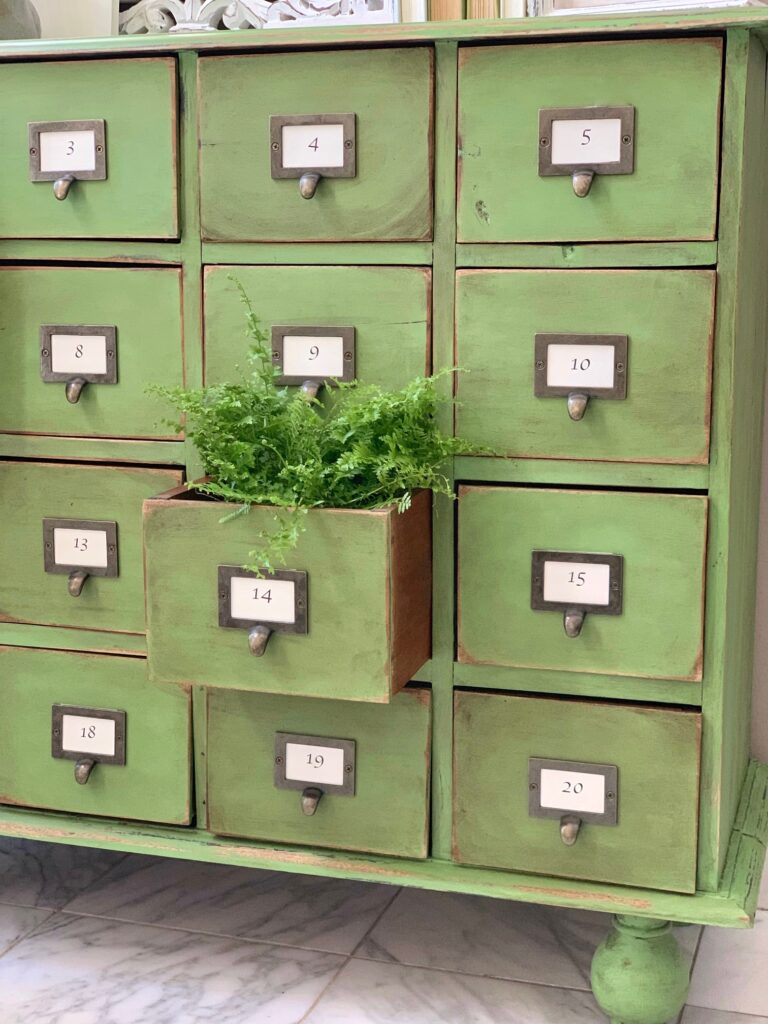 close up of a green apothecary that was painted with Annie sloan and distressed with sandpaper