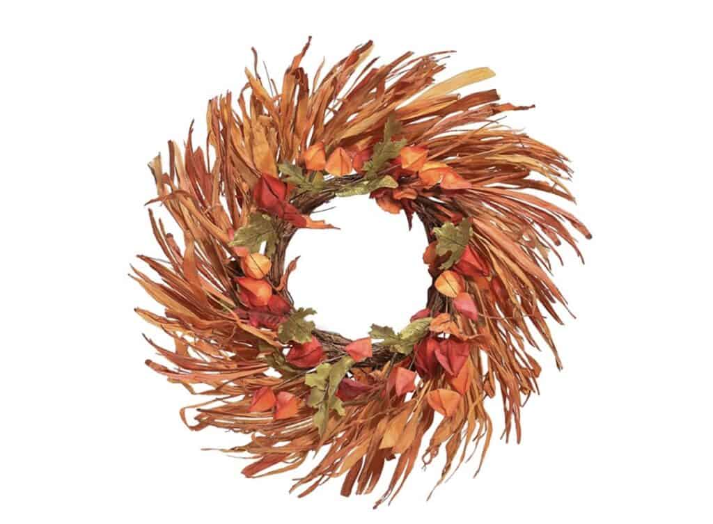 bright orange wreath with grass, chinese lanterns and maple leaves. 