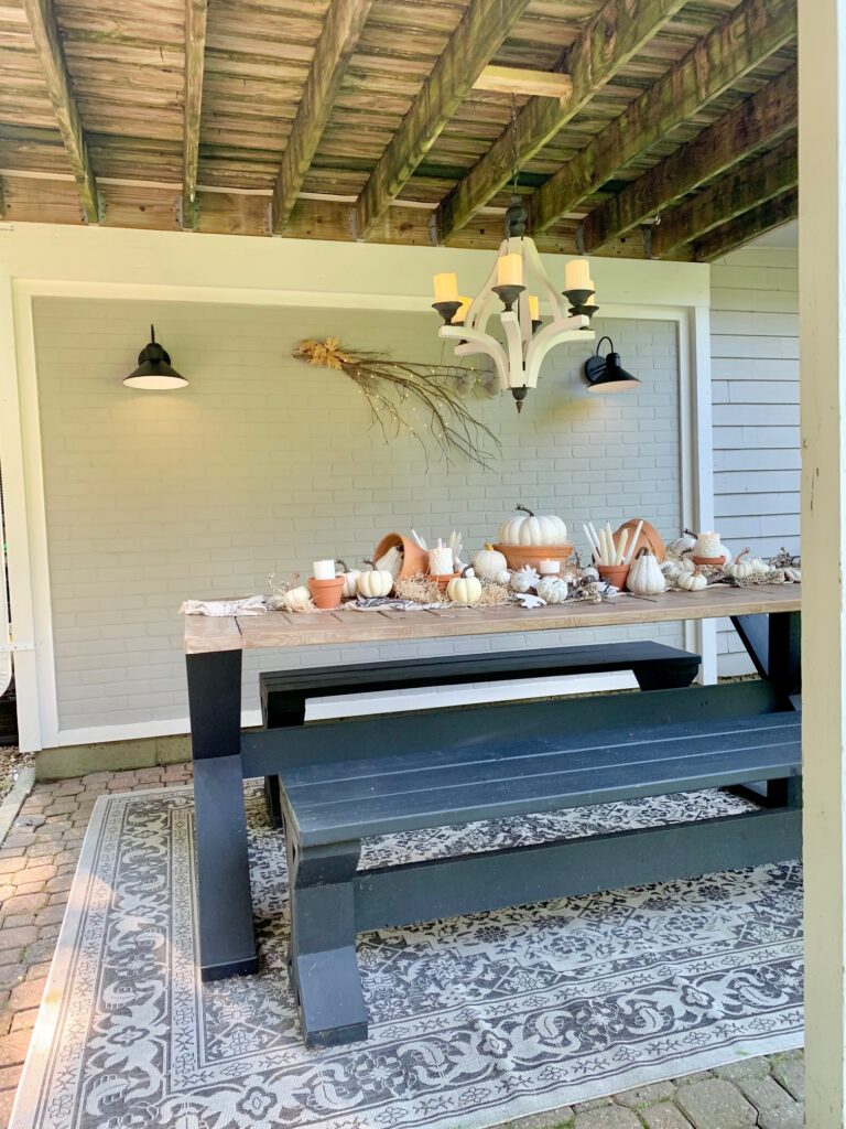 outdoor dining space with chandelier with battery operated candles. 