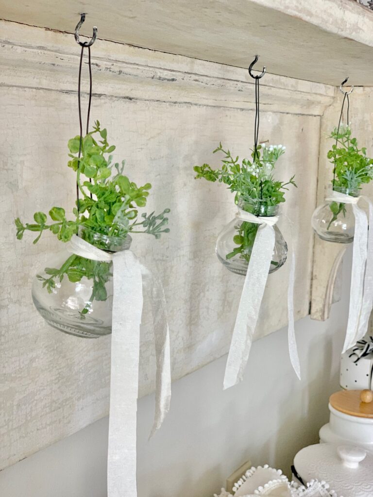 ball jars hanging with greens. 