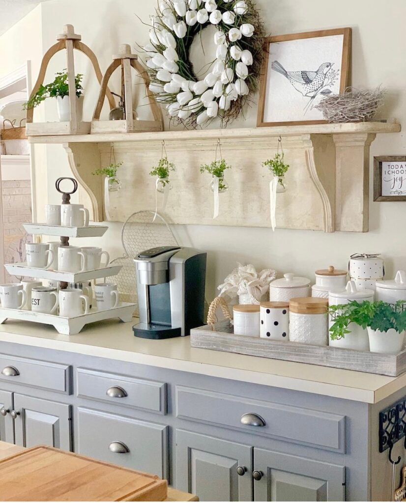 Spring decorated coffee bar with open lanterns, a white tulip wreath and bird print. 