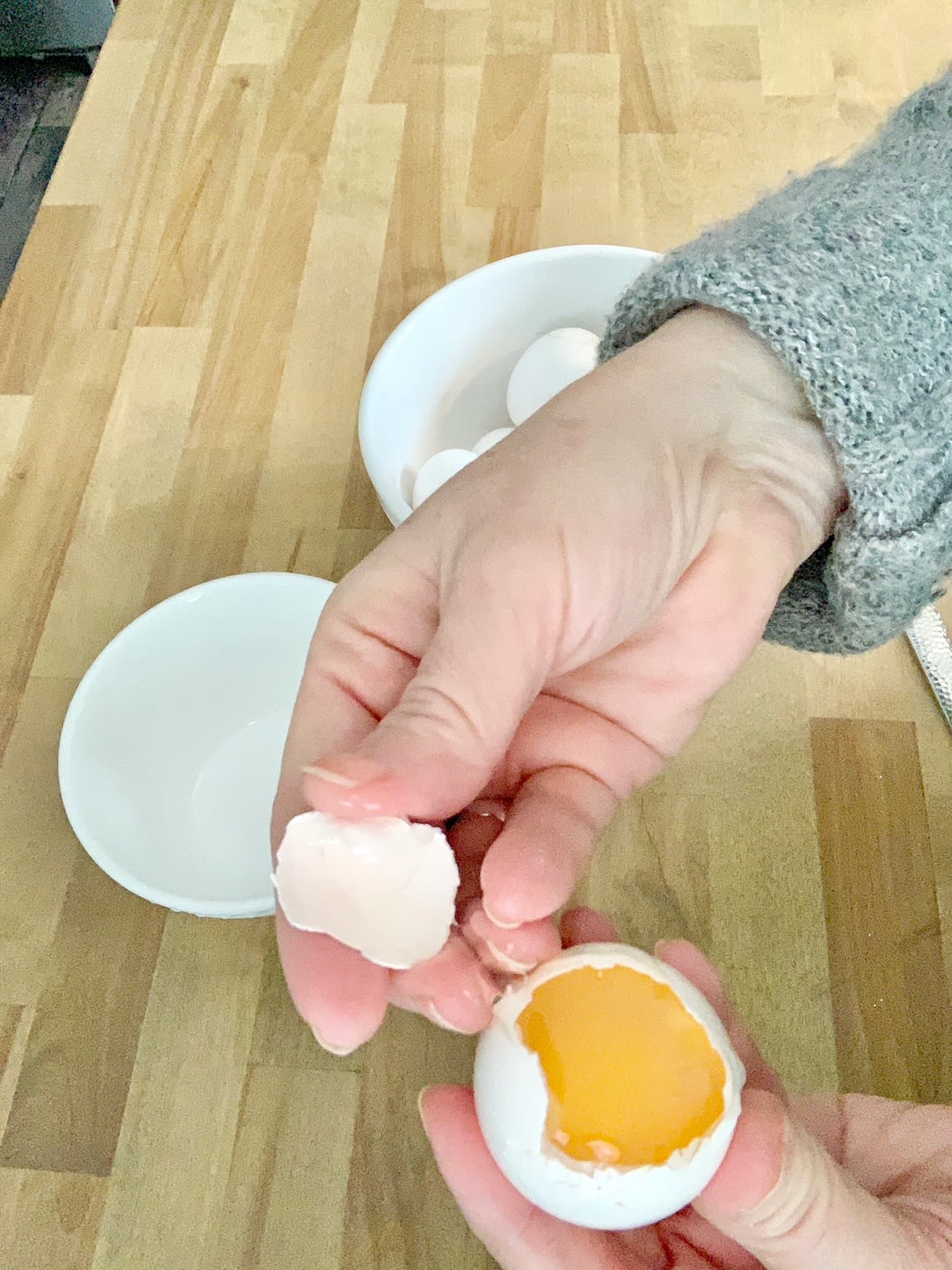 Taking the egg top off of the egg.