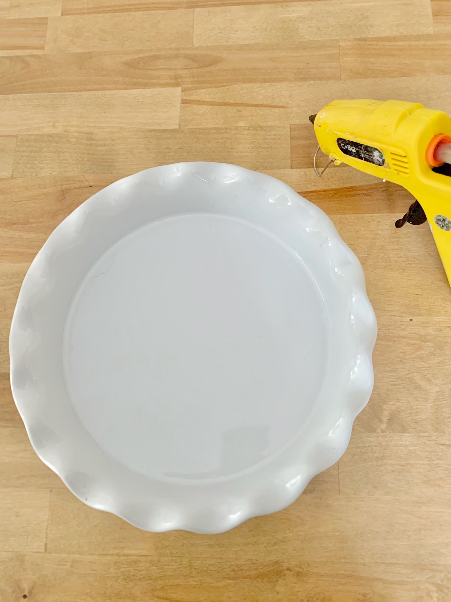 Pie plate and glue gun.