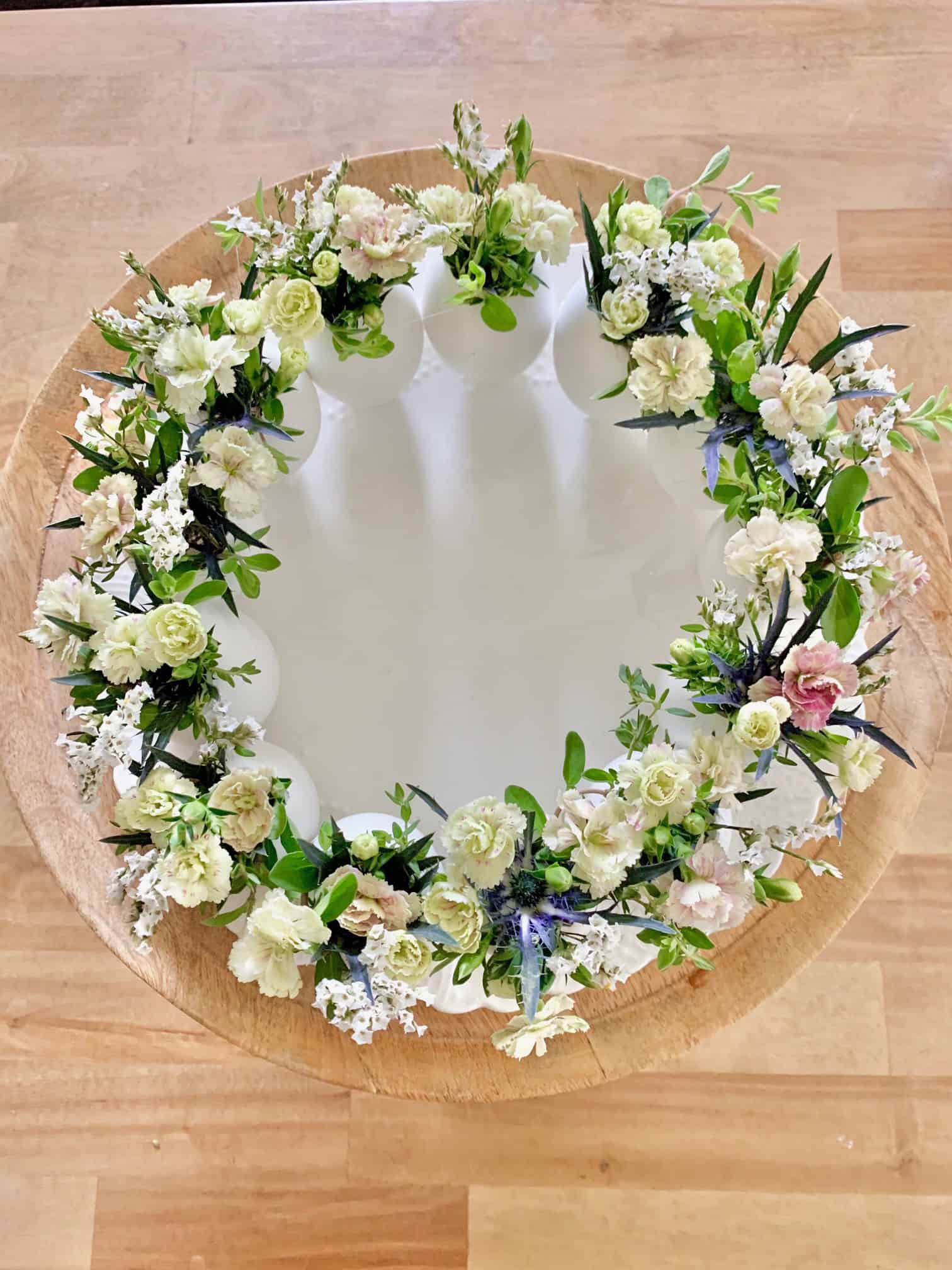 Top view of this easter centerpiece made with fresh eggs and flowers. 