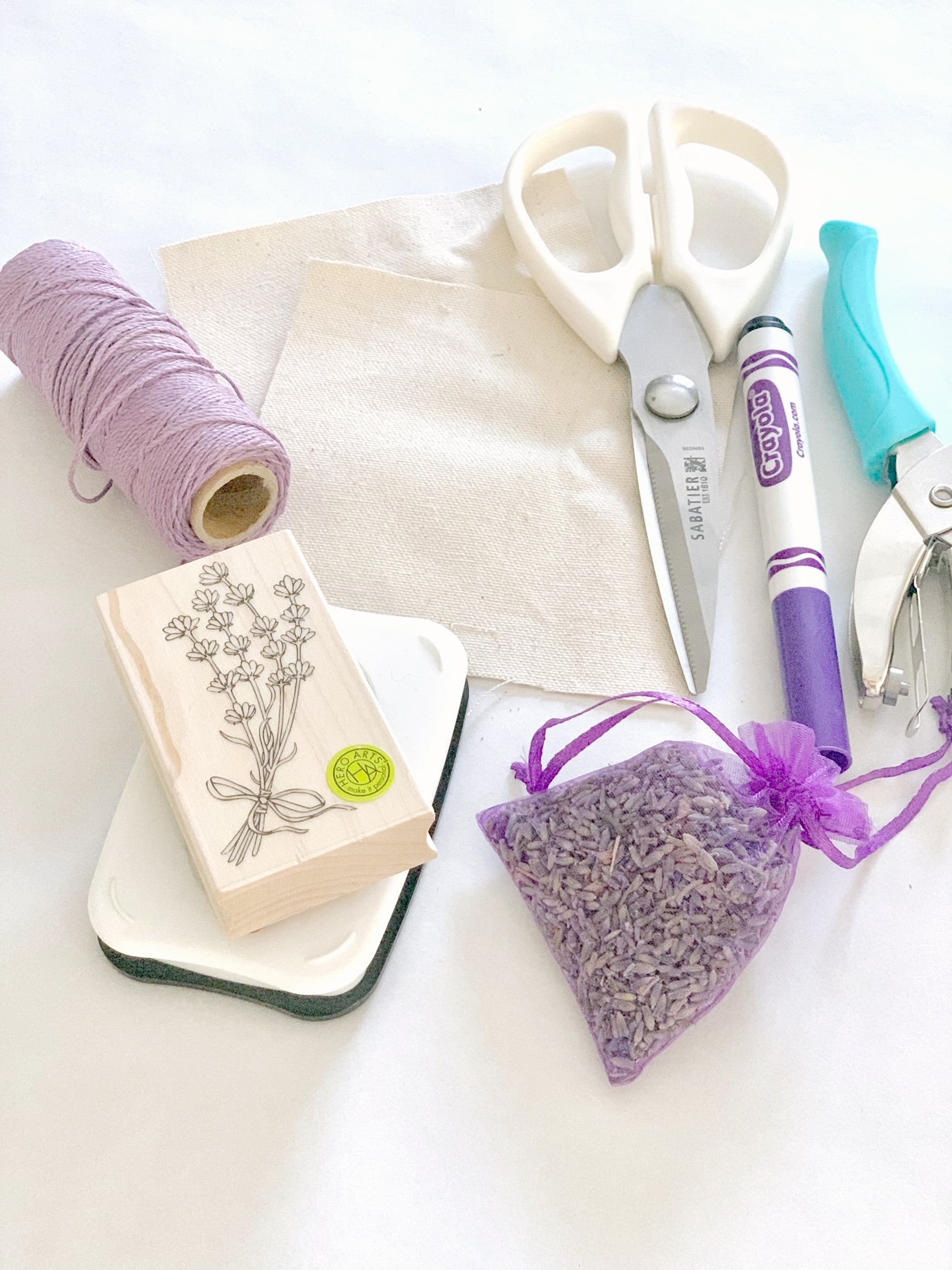 The tools and supplies for this project. Scissor, stamp and ink pad, lavender in a pouch and a marker.