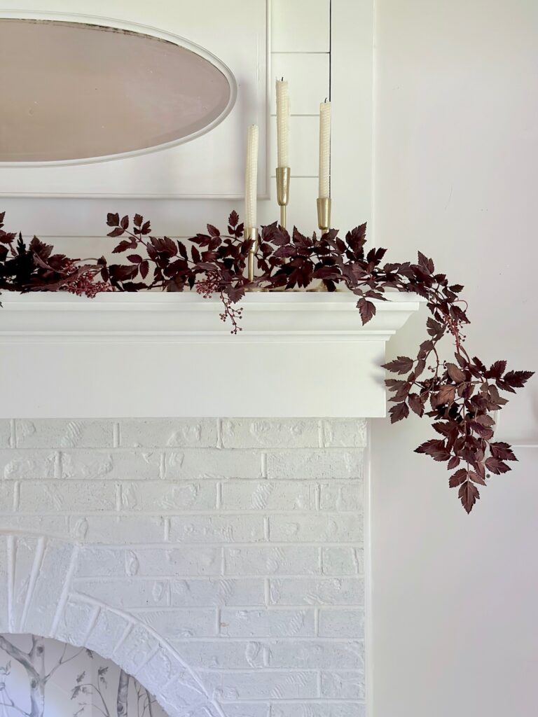 white mantel and painted brick fireplace.