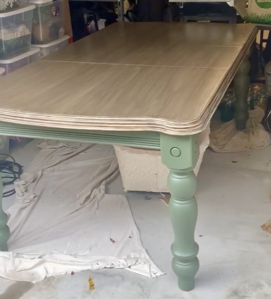dining table with Bayberry green legs and skirt with faux wood top. This table has a smooth wood finish. 