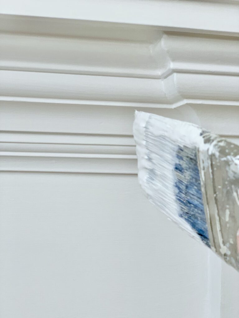 A paint brush with white paint.