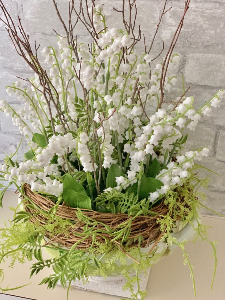 dried arrangement featuring lily of the valley. 