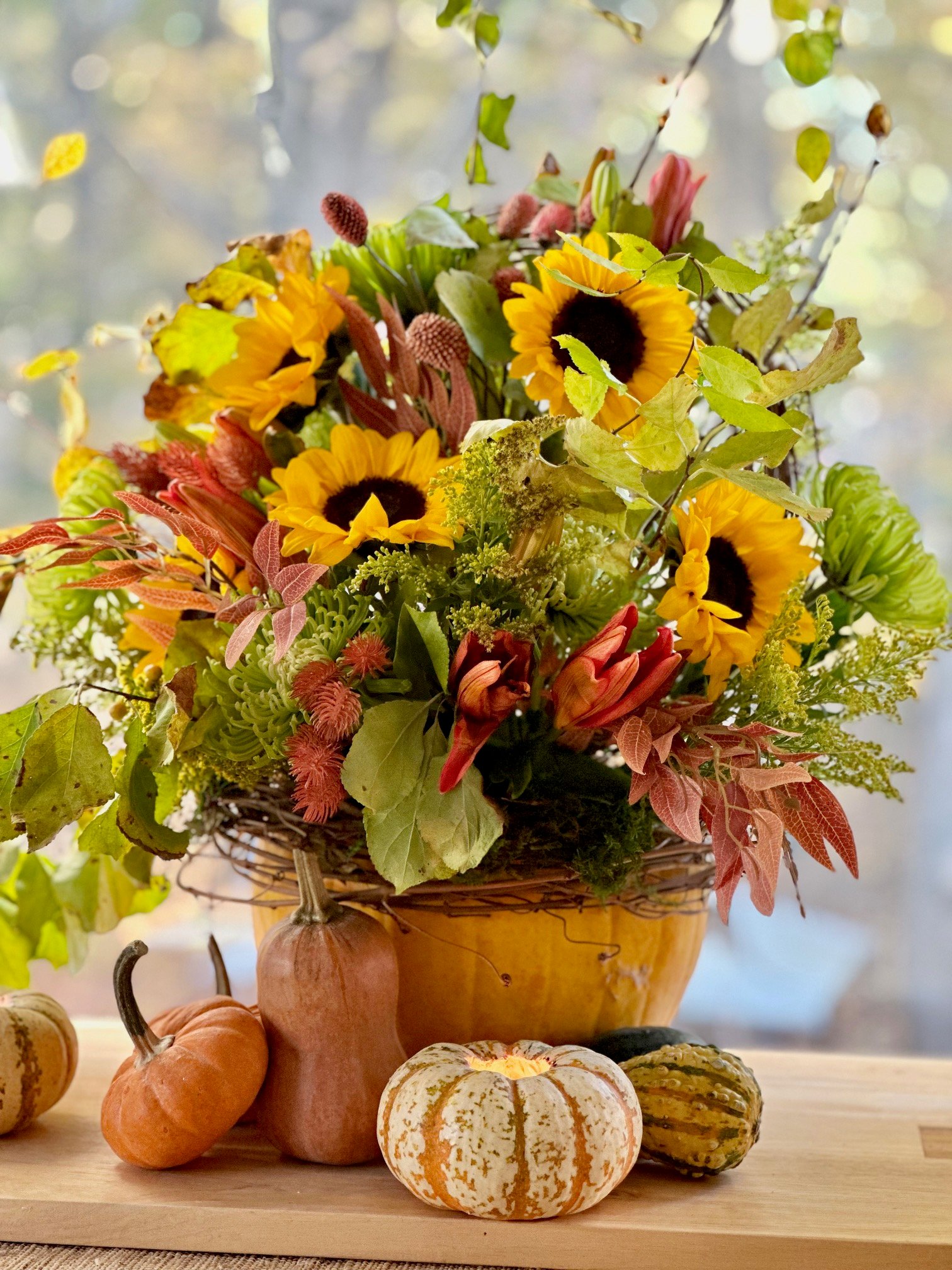 Beautiful bright fall flowers arrangement in a yellow pumpkin. This pumpkin has a liner placed in it to hold wet foam.