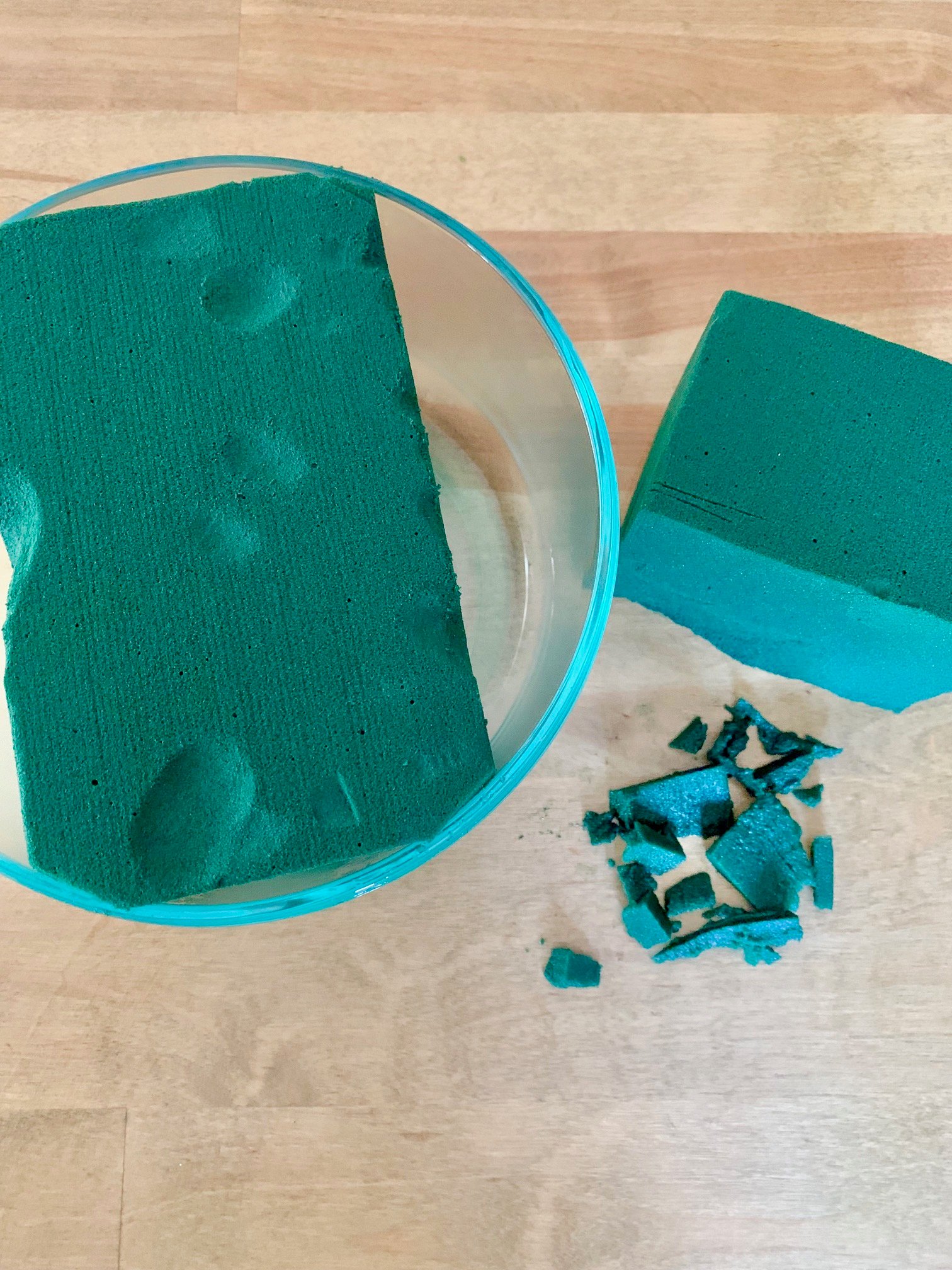 Fitting floral foam in a glass container.