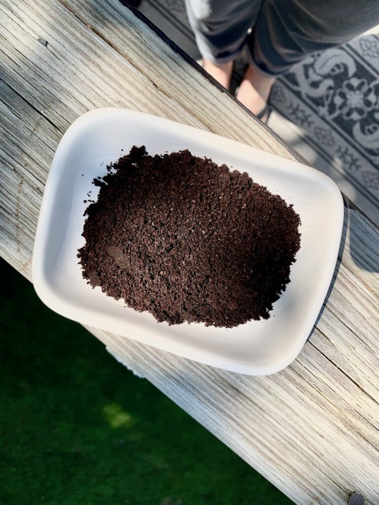 a small dish of coffee grounds. 