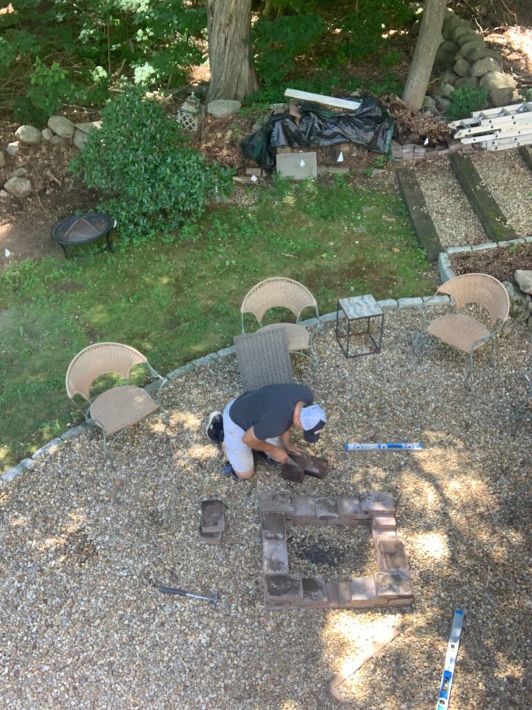 top view of my husband building the diy paver ire pit. 