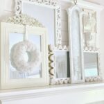 layered mirrors all with white a cream frames with an Easy DIY Cupcake Liner flower wreath.