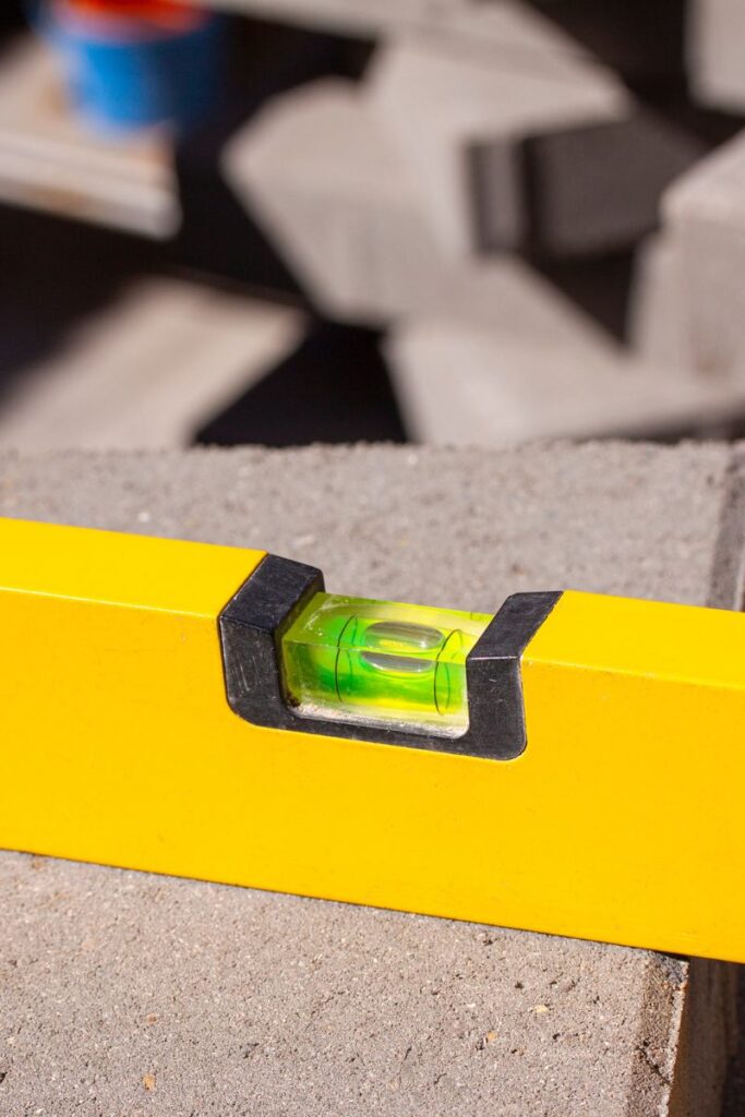 a close up photo of a level sitting on a paver. 